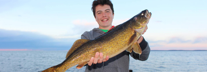 Lake Michigan Fishing Charters Boy Holding A Walleye