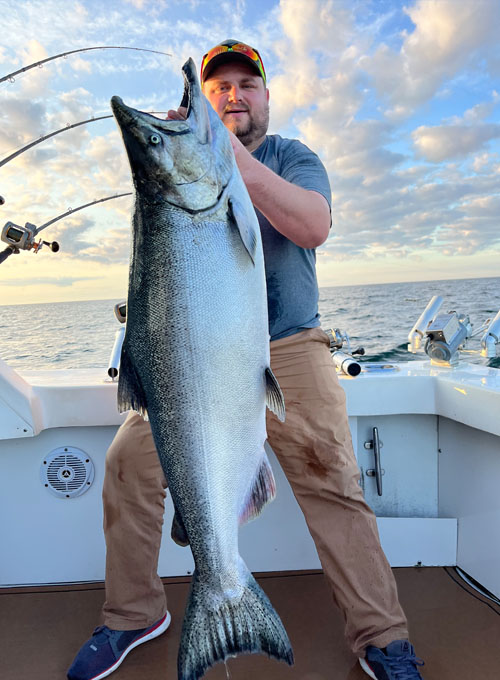 Lake Michigan Fishing Charters Man Holding A Salmon