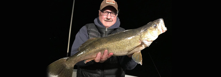 Lake Michigan Fishing Charters Man Holding A Walleye
