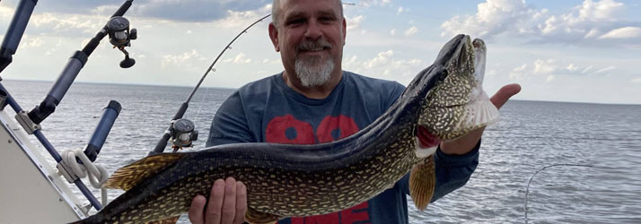 Lake Michigan Fishing Charters Man Holding A Walleye