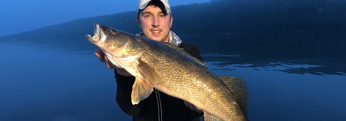 Lake Michigan Fishing Charters Young Man Holding A Walleye